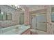 Bathroom with tub, sink, and patterned wallpaper at 417 N Riverside Dr, Edgewater, FL 32132