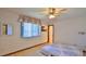 Bright bedroom with wood floors, window, and ceiling fan at 417 N Riverside Dr, Edgewater, FL 32132