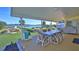 Covered patio overlooking the water with table and chairs at 417 N Riverside Dr, Edgewater, FL 32132