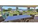 Covered patio overlooking the water with outdoor dining set at 417 N Riverside Dr, Edgewater, FL 32132