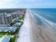 Wide aerial showcasing oceanfront location and beachfront community at 4225 S Atlantic Ave # 144, New Smyrna Beach, FL 32169