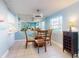 Dining room with glass table and four chairs, view of kitchen at 4225 S Atlantic Ave # 144, New Smyrna Beach, FL 32169