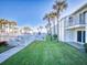 Ground-level view of condo building, lush lawn, and ocean view at 4225 S Atlantic Ave # 144, New Smyrna Beach, FL 32169