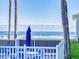 Ocean view from patio, white fence and palm trees at 4225 S Atlantic Ave # 144, New Smyrna Beach, FL 32169