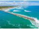 Aerial view of long jetty and ocean waves at 4367 S Peninsula Dr, Ponce Inlet, FL 32127