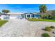 Charming beachfront home with paver driveway and landscaped yard at 4367 S Peninsula Dr, Ponce Inlet, FL 32127