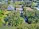 Aerial view of waterfront home with private dock and lush landscaping at 4514 Saxon Dr, New Smyrna Beach, FL 32169