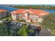 Aerial view of waterfront condo building with parking and water access at 460 Bouchelle Dr # 304, New Smyrna Beach, FL 32169