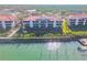 Waterfront condo building with private docks and lush landscaping at 460 Bouchelle Dr # 304, New Smyrna Beach, FL 32169