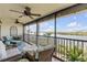 Relaxing balcony with wicker furniture and waterfront views at 460 Bouchelle Dr # 304, New Smyrna Beach, FL 32169