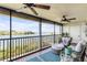 Relaxing screened balcony overlooking the water with patio furniture at 460 Bouchelle Dr # 304, New Smyrna Beach, FL 32169