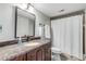 Bathroom with granite countertop, dark brown vanity, and shower/tub combo at 460 Bouchelle Dr # 304, New Smyrna Beach, FL 32169