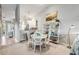 Bright dining area with white table and chairs, adjacent to kitchen at 460 Bouchelle Dr # 304, New Smyrna Beach, FL 32169