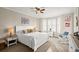 Main bedroom with a white bed, rocking chair and bay window at 4628 Harbour Village Blvd # 2206, Ponce Inlet, FL 32127