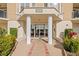 Condo building entrance with columns and landscaping at 4628 Harbour Village Blvd # 2206, Ponce Inlet, FL 32127