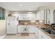 Modern kitchen featuring white cabinets and granite countertops at 4628 Harbour Village Blvd # 2206, Ponce Inlet, FL 32127