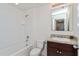 Clean bathroom with tub, toilet, vanity, and mirror at 4825 Apple Blossom Ln, Saint Cloud, FL 34771