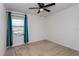 Bedroom with teal curtains and ceiling fan at 4825 Apple Blossom Ln, Saint Cloud, FL 34771