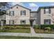 Tan two-story house with green shutters and landscaping at 4825 Apple Blossom Ln, Saint Cloud, FL 34771