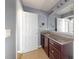 Bathroom features a granite countertop, dark wood cabinets, and a large mirror at 526 Mount Olympus Blvd, New Smyrna Beach, FL 32168