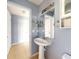 Simple bathroom with pedestal sink and mirror at 526 Mount Olympus Blvd, New Smyrna Beach, FL 32168