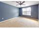 Large bedroom with ceiling fan and neutral carpeting at 526 Mount Olympus Blvd, New Smyrna Beach, FL 32168