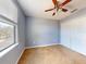 Bright bedroom with neutral walls, carpeting, and ceiling fan at 526 Mount Olympus Blvd, New Smyrna Beach, FL 32168