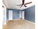 Bright bedroom featuring ceiling fan and ample closet space at 526 Mount Olympus Blvd, New Smyrna Beach, FL 32168