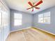 Spacious bedroom with two windows and ceiling fan at 526 Mount Olympus Blvd, New Smyrna Beach, FL 32168