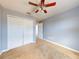 Bedroom with neutral walls, carpeting, ceiling fan, and double doors to closet at 526 Mount Olympus Blvd, New Smyrna Beach, FL 32168