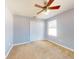 Well-lit bedroom with ceiling fan and double-door closet at 526 Mount Olympus Blvd, New Smyrna Beach, FL 32168