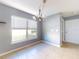 Bright dining room features tile floors, a chandelier, and window blinds at 526 Mount Olympus Blvd, New Smyrna Beach, FL 32168