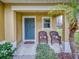 Inviting front porch with wicker chairs and landscaping at 526 Mount Olympus Blvd, New Smyrna Beach, FL 32168