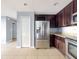 Kitchen features stainless steel refrigerator and dark wood cabinets at 526 Mount Olympus Blvd, New Smyrna Beach, FL 32168