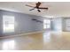 Living room with tile floors, large windows and ceiling fan at 526 Mount Olympus Blvd, New Smyrna Beach, FL 32168