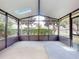 Spacious screened porch overlooks a lush backyard with trees and a pond at 526 Mount Olympus Blvd, New Smyrna Beach, FL 32168