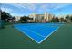 Two blue tennis courts with green surrounding at 5300 S Atlantic Ave # 16201, New Smyrna Beach, FL 32169