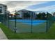 Two blue tennis courts with green surrounding at 5300 S Atlantic Ave # 16201, New Smyrna Beach, FL 32169