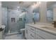 Elegant bathroom with a frameless shower and double vanity at 555 Wildwood Dr, New Smyrna Beach, FL 32168