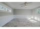 Well-lit bedroom with wainscoting, wood-look floors, and large windows at 555 Wildwood Dr, New Smyrna Beach, FL 32168