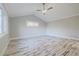 Bright bedroom with vaulted ceiling, wood-look floors and a ceiling fan at 555 Wildwood Dr, New Smyrna Beach, FL 32168