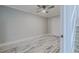 Bright bedroom with whitewashed floors and ceiling fan at 555 Wildwood Dr, New Smyrna Beach, FL 32168