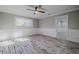 Spacious bedroom with wood-look floors and access to another room at 555 Wildwood Dr, New Smyrna Beach, FL 32168