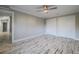 Large bedroom with wood-look floors, double closets and a ceiling fan at 555 Wildwood Dr, New Smyrna Beach, FL 32168