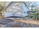 White garage door and exterior of home at 555 Wildwood Dr, New Smyrna Beach, FL 32168