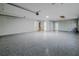 Spacious garage with epoxy floor and additional storage at 555 Wildwood Dr, New Smyrna Beach, FL 32168