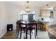 Dining room with a wooden table and chairs, leading to the kitchen at 660 Biscayne Dr, Orange City, FL 32763