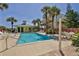 Refreshing community pool with ample lounge chairs and patio space at 6612 S Atlantic Ave # 201, New Smyrna Beach, FL 32169