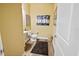 Small powder room with a pedestal sink and wood-look flooring at 6932 Vintage Ln, Port Orange, FL 32128