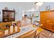 Lighted dining area with wooden table and view into the living room at 6932 Vintage Ln, Port Orange, FL 32128
